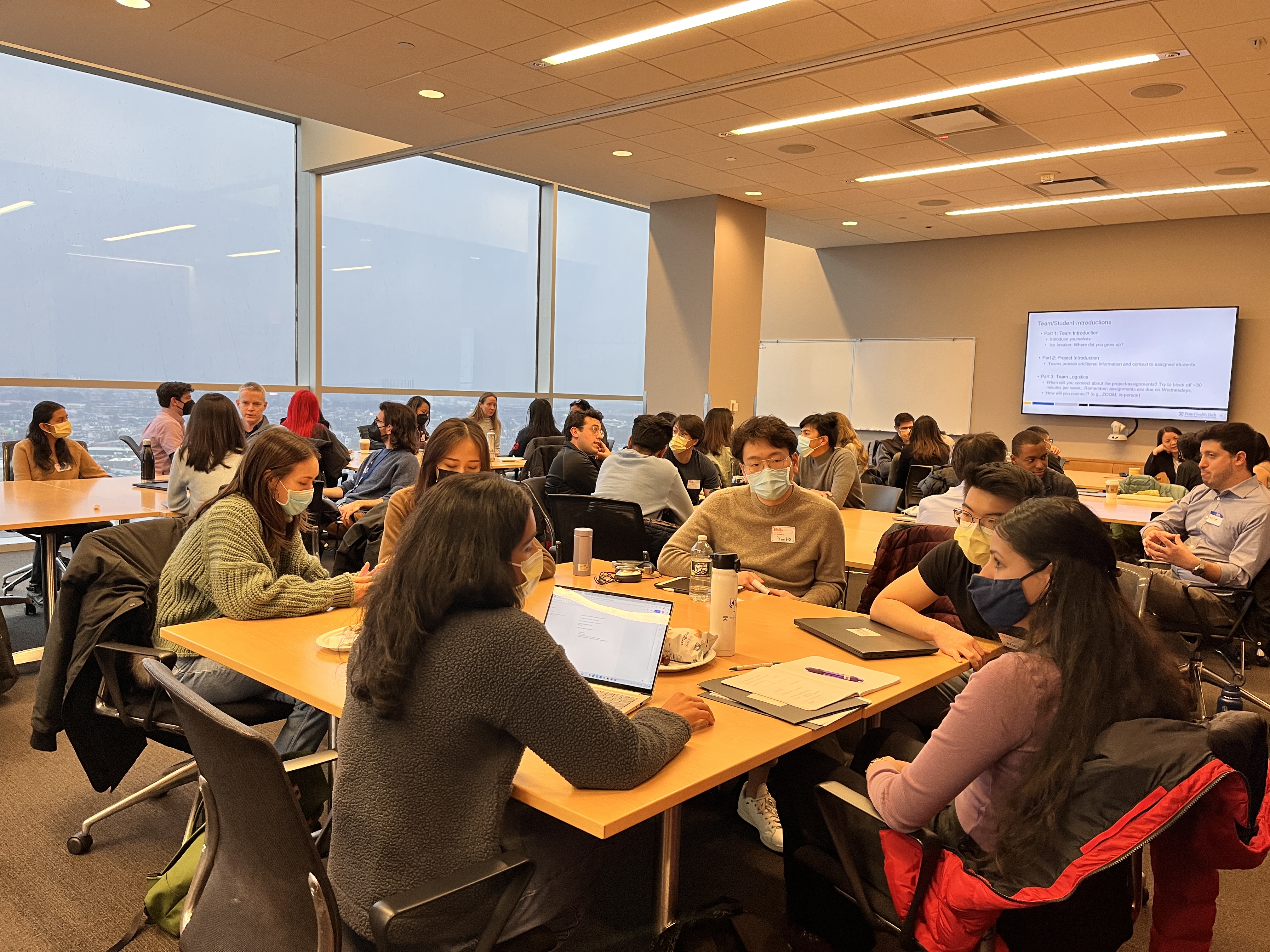 classroom full of students and clinicians working in groups